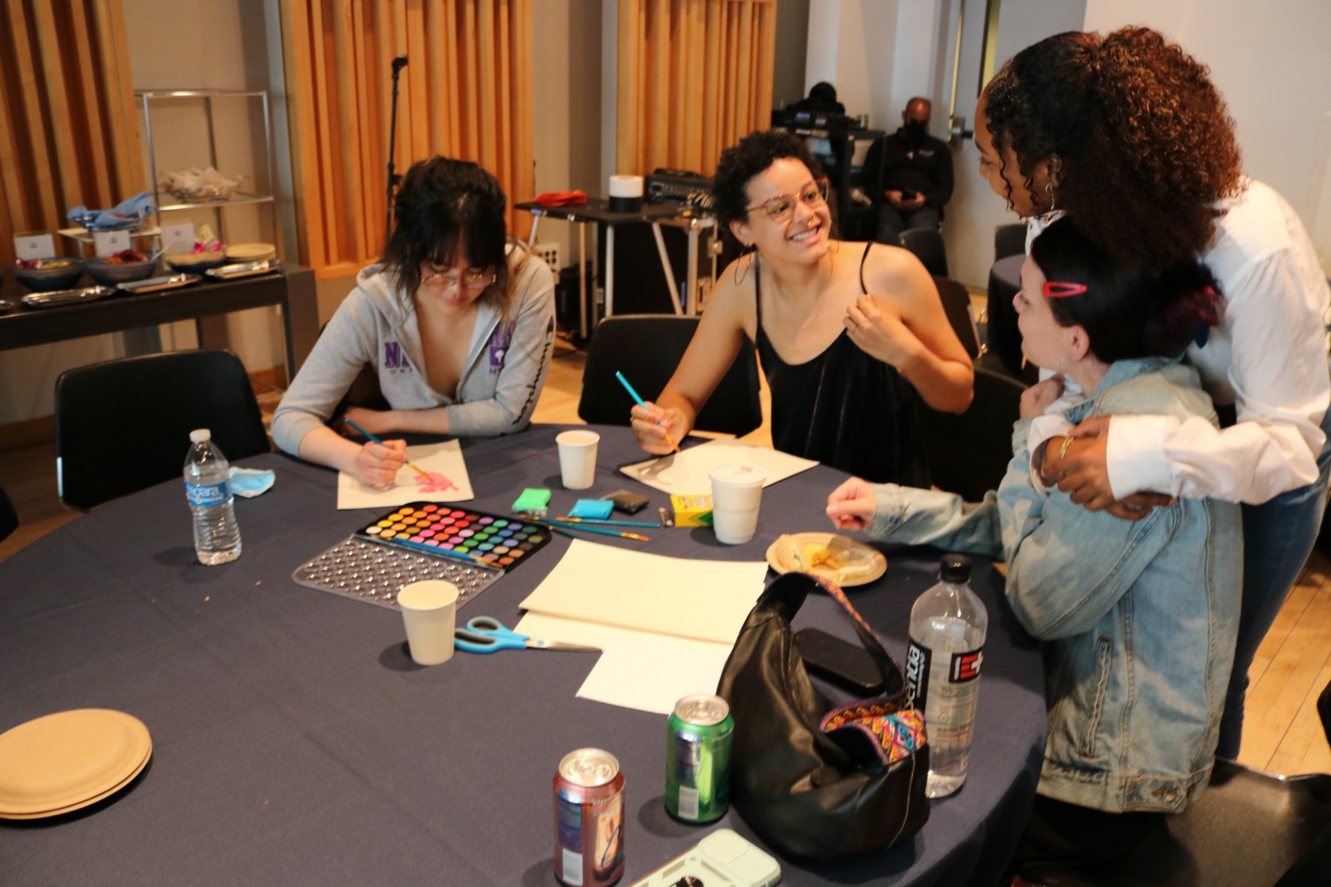 Image of audience members painting arts and crafts